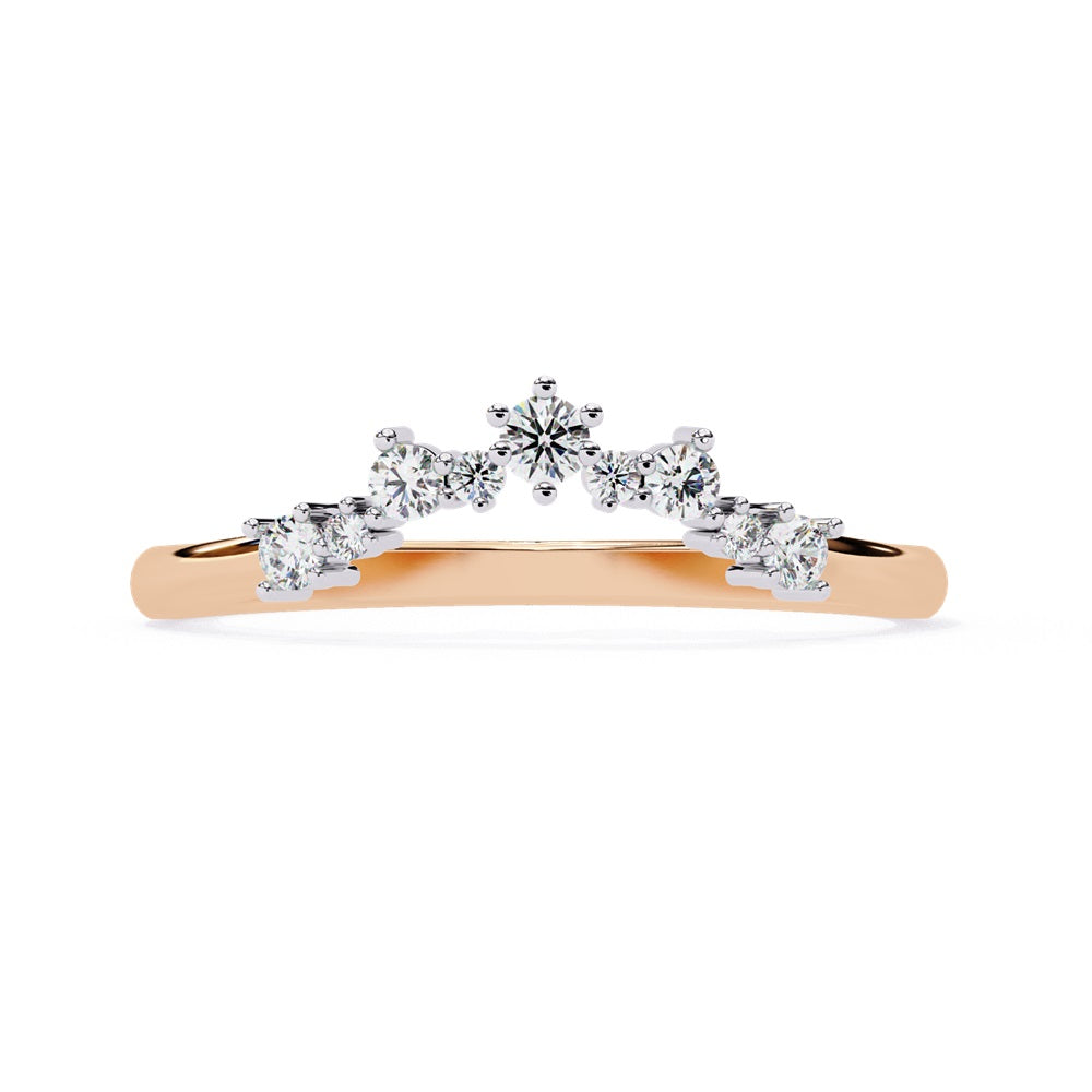 The Timeless Diamond Chevron Band by Niraa is a luxury accessory featuring a gold band with a row of seven small, sparkling diamonds in a crescent shape. The larger central stone creates a tiara-like design, epitomizing elegance when photographed against a white background.