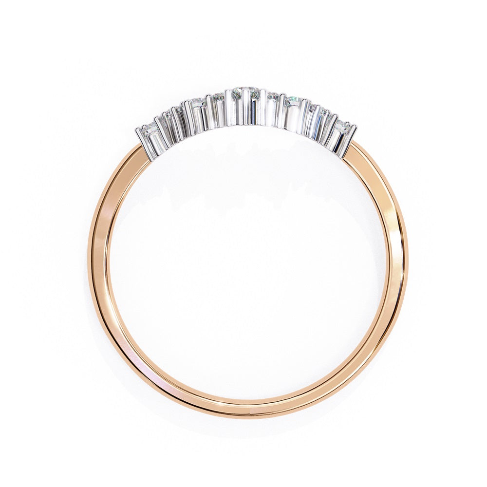 The Timeless Diamond Chevron Band by Niraa is a luxury accessory featuring a gold band with a row of seven small, sparkling diamonds in a crescent shape. The larger central stone creates a tiara-like design, epitomizing elegance when photographed against a white background.