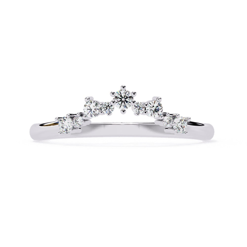 The Timeless Diamond Chevron Band by Niraa is a luxury accessory featuring a gold band with a row of seven small, sparkling diamonds in a crescent shape. The larger central stone creates a tiara-like design, epitomizing elegance when photographed against a white background.