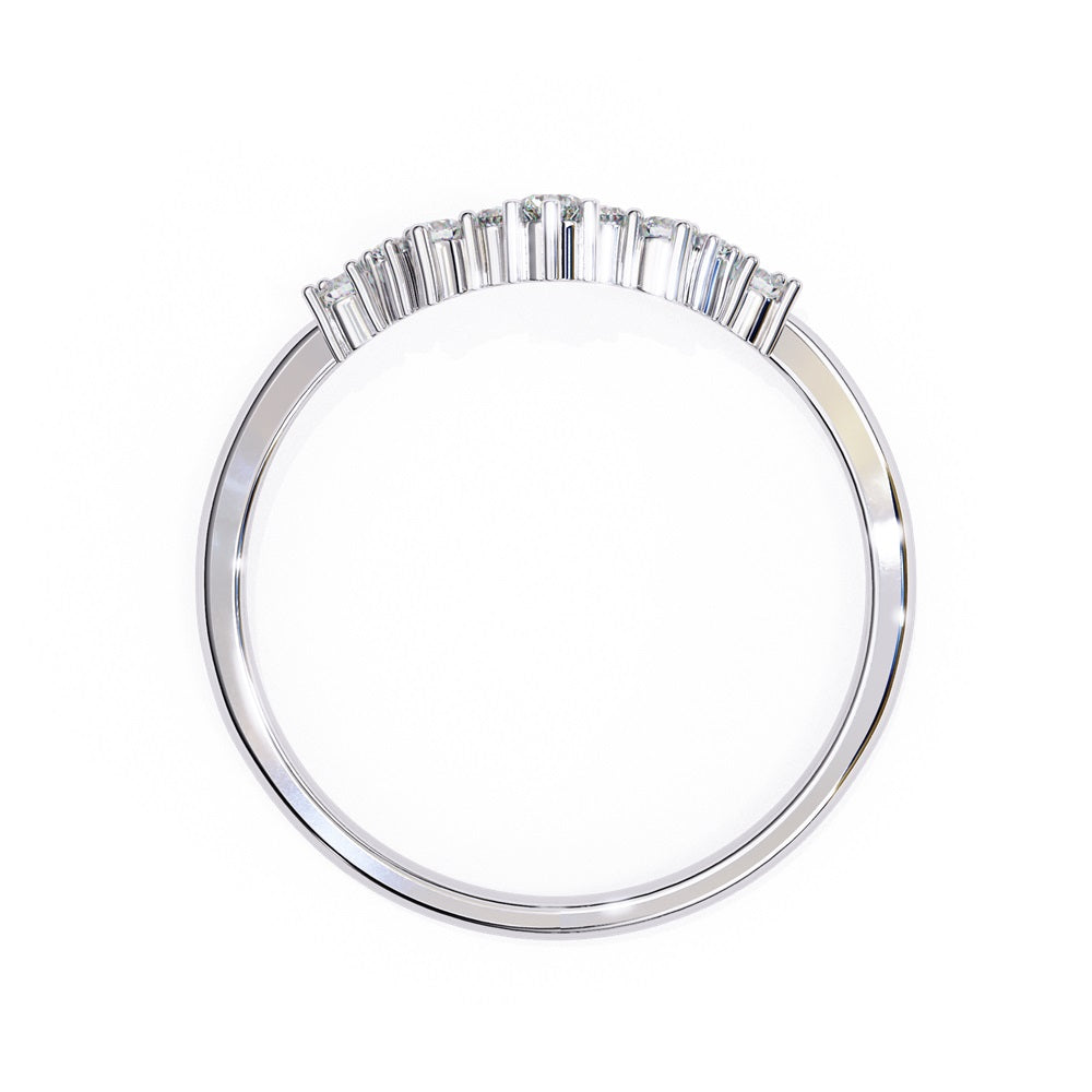 The Timeless Diamond Chevron Band by Niraa is a luxury accessory featuring a gold band with a row of seven small, sparkling diamonds in a crescent shape. The larger central stone creates a tiara-like design, epitomizing elegance when photographed against a white background.