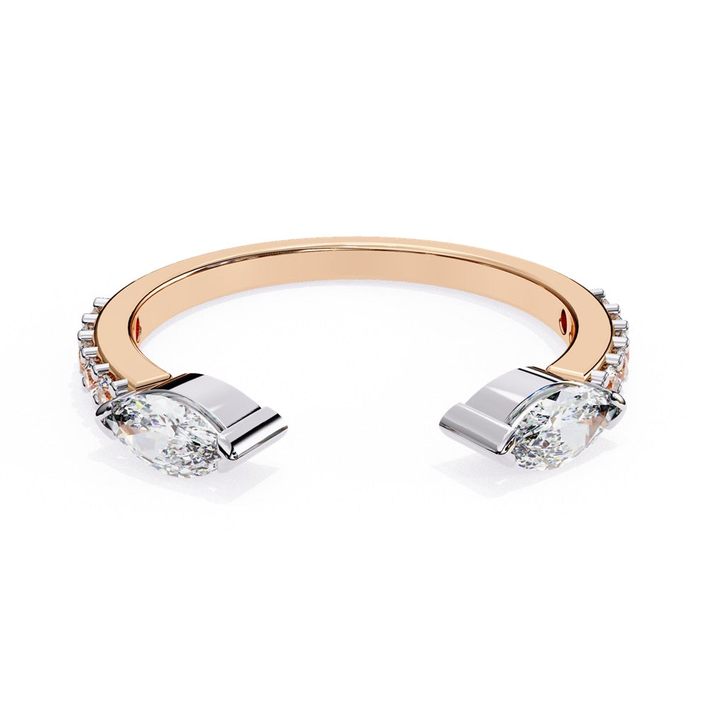 The Niraa Marquise Diamond Open Band is a luxury accessory with gold and silver featuring large marquise-cut diamonds at each end. Smaller rectangular diamonds sparkle on the sides, set against a plain white background.