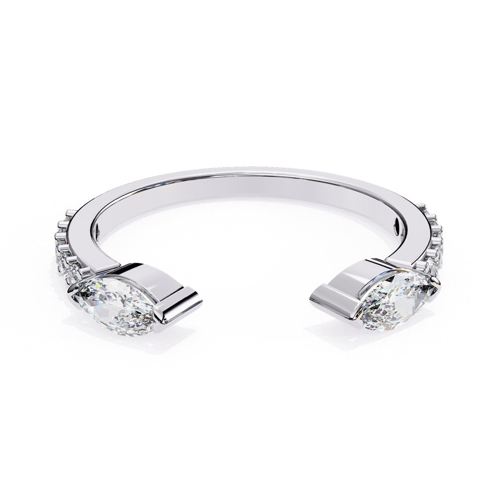 The Niraa Marquise Diamond Open Band is a luxury accessory with gold and silver featuring large marquise-cut diamonds at each end. Smaller rectangular diamonds sparkle on the sides, set against a plain white background.