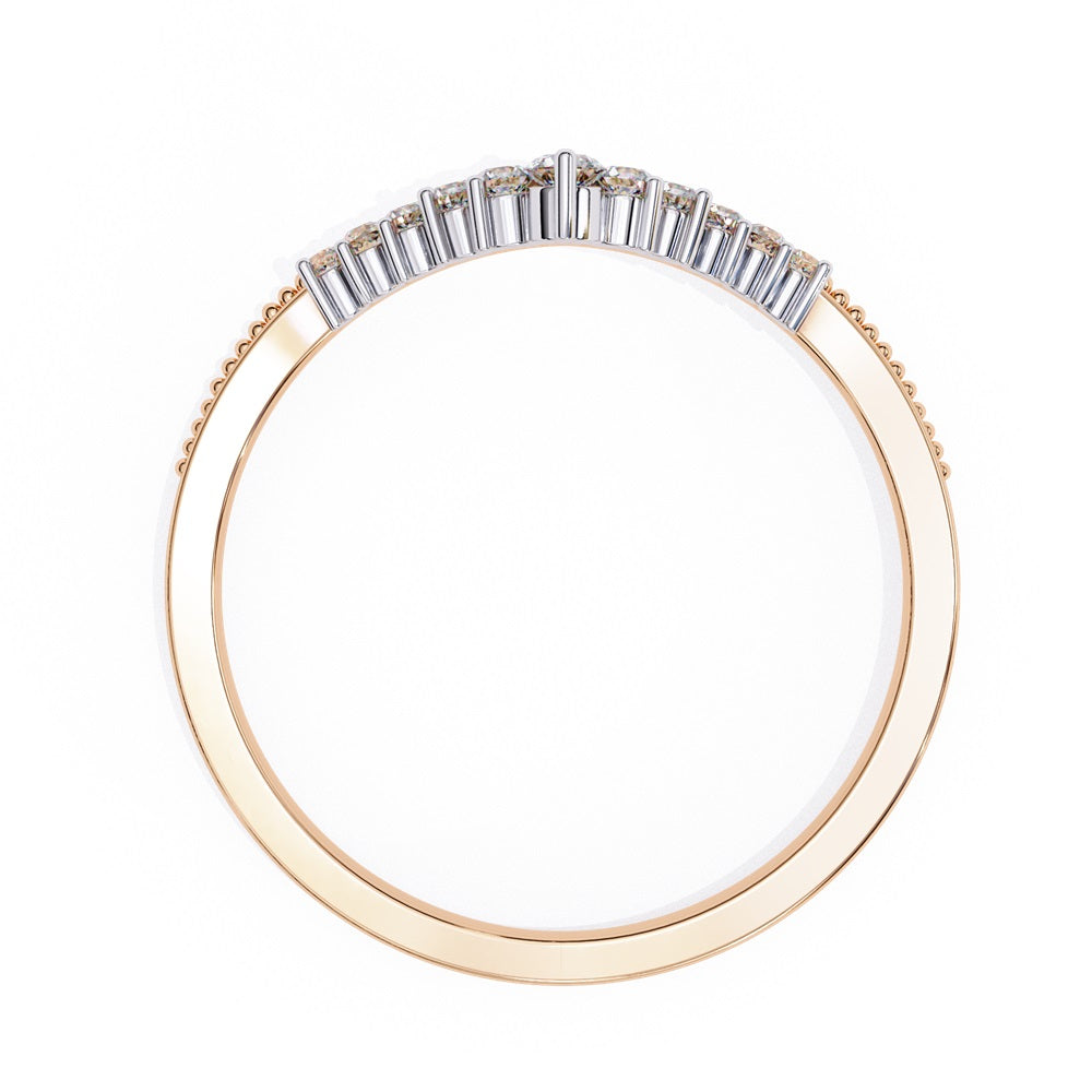 The Tiara Diamond Chevron Band by Niraa showcases a crown-like elegance with its gold band and row of sparkling diamonds, highlighted by a larger central diamond at the peak—an epitome of luxury.