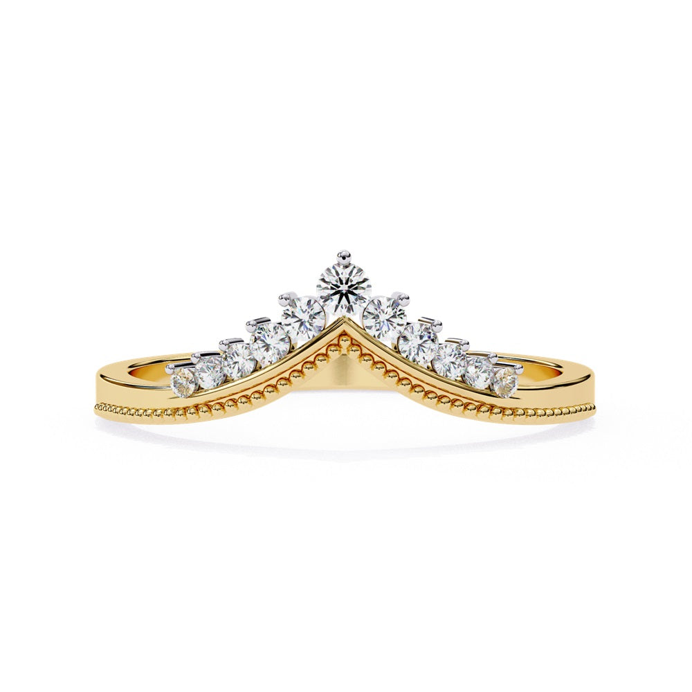 The Tiara Diamond Chevron Band by Niraa showcases a crown-like elegance with its gold band and row of sparkling diamonds, highlighted by a larger central diamond at the peak—an epitome of luxury.