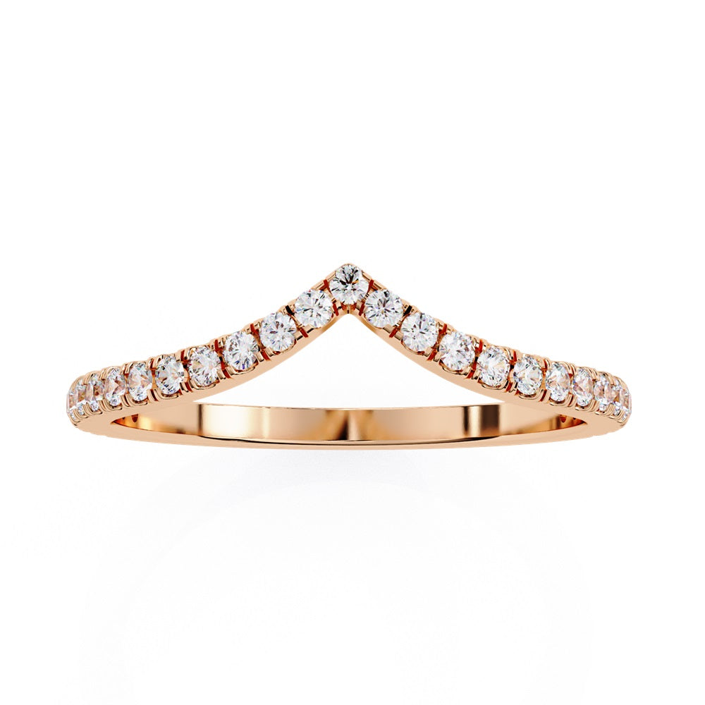 The Stackable Diamond Chevron Band by Niraa is a thin gold ring featuring a chevron design with sparkling diamonds on the top edge, perfect for your stackable ring collection against a white background.