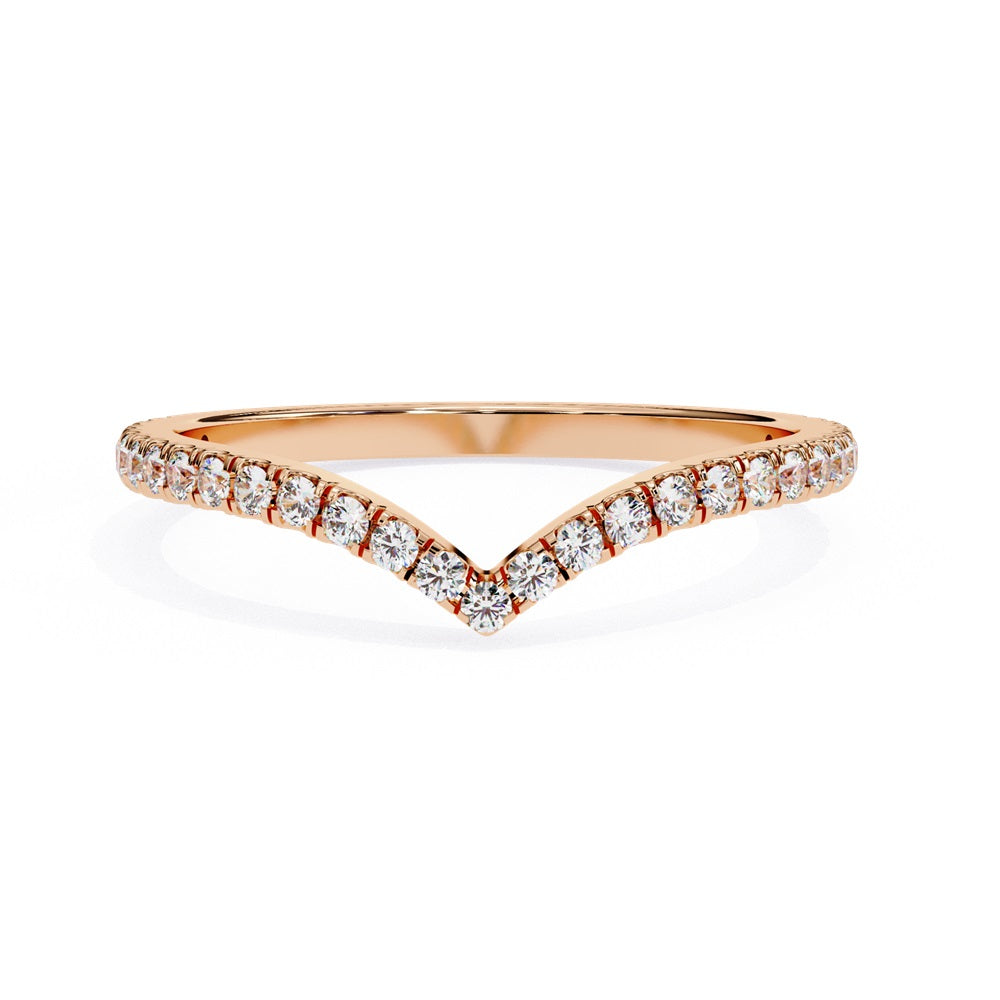 The Stackable Diamond Chevron Band by Niraa is a thin gold ring featuring a chevron design with sparkling diamonds on the top edge, perfect for your stackable ring collection against a white background.