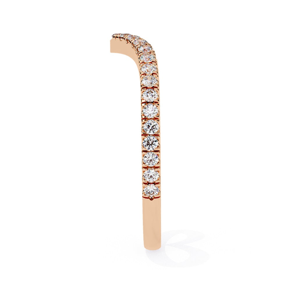 The Stackable Diamond Chevron Band by Niraa is a thin gold ring featuring a chevron design with sparkling diamonds on the top edge, perfect for your stackable ring collection against a white background.