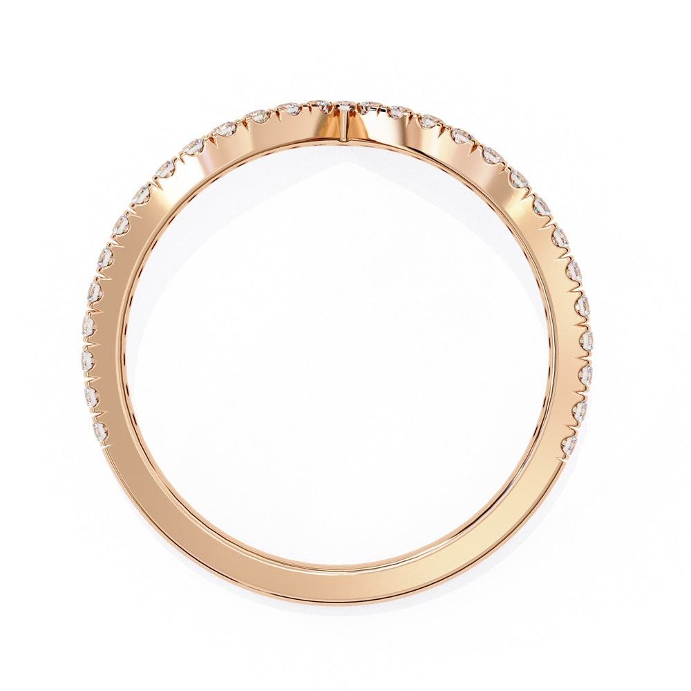 The Stackable Diamond Chevron Band by Niraa is a thin gold ring featuring a chevron design with sparkling diamonds on the top edge, perfect for your stackable ring collection against a white background.