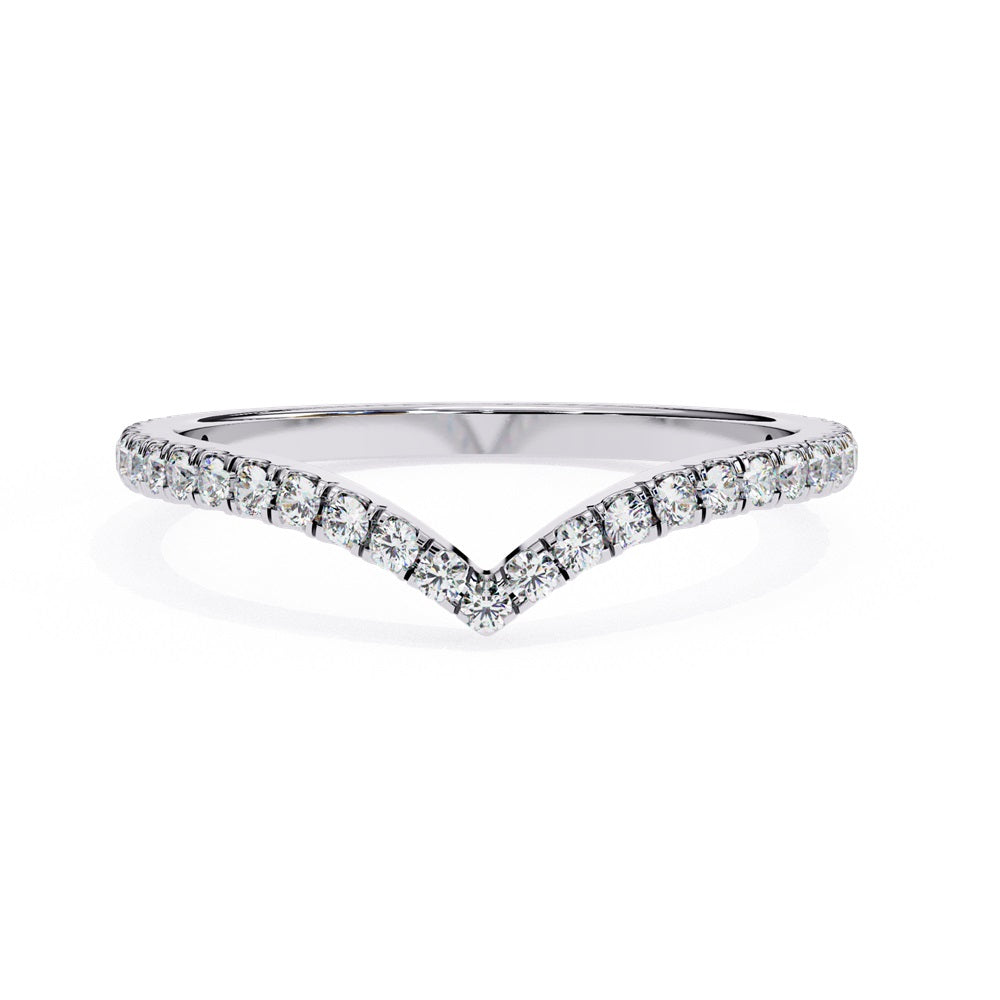 The Stackable Diamond Chevron Band by Niraa is a thin gold ring featuring a chevron design with sparkling diamonds on the top edge, perfect for your stackable ring collection against a white background.