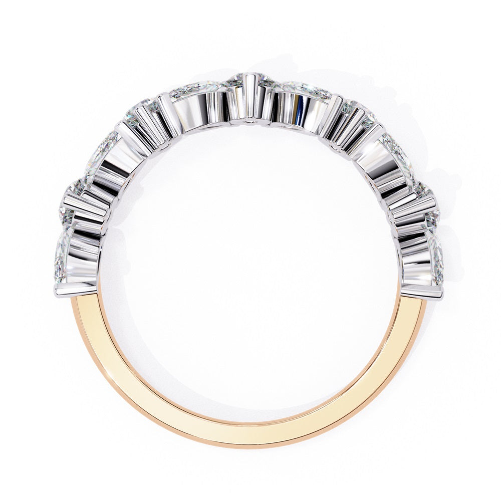 The Symphony Diamond Band by Niraa is a luxurious gold and silver ring with a central round diamond, flanked by marquise-cut diamonds for an elegant, symmetrical design.