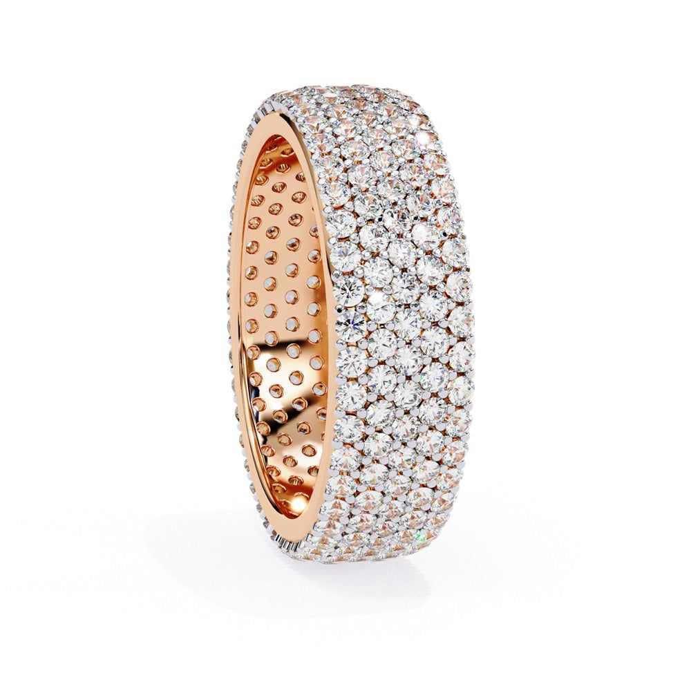 The Niraa Glimmering Diamond Eternity Band boasts five luxurious rows of closely set, round-cut white diamonds against a white background, highlighting its elegant craftsmanship and sparkle.
