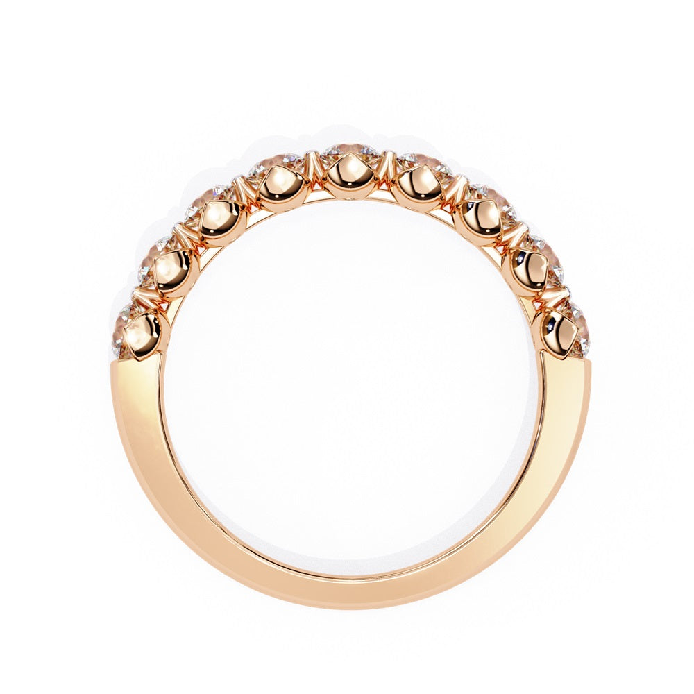 The Minimal Magic Diamond Band by Niraa is a luxury accessory featuring round, sparkling white diamonds, each set in its own bezel. The diamonds catch the light brilliantly, giving this gold ring an elegant and opulent allure.