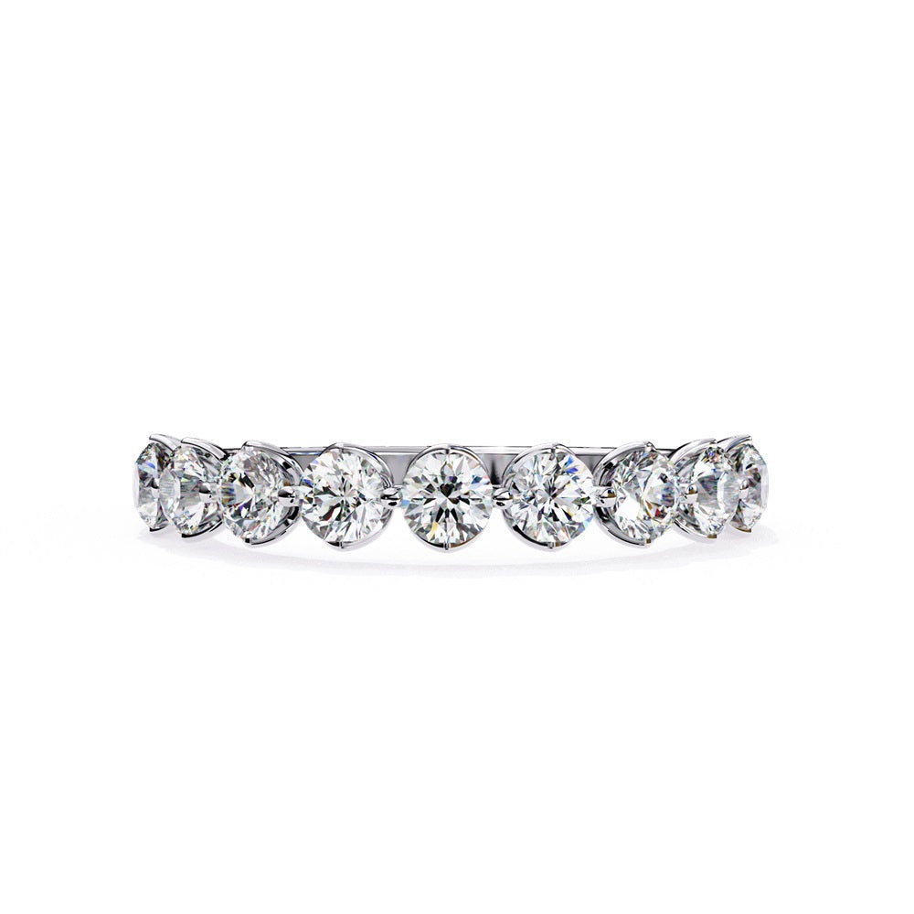 The Minimal Magic Diamond Band by Niraa is a luxury accessory featuring round, sparkling white diamonds, each set in its own bezel. The diamonds catch the light brilliantly, giving this gold ring an elegant and opulent allure.