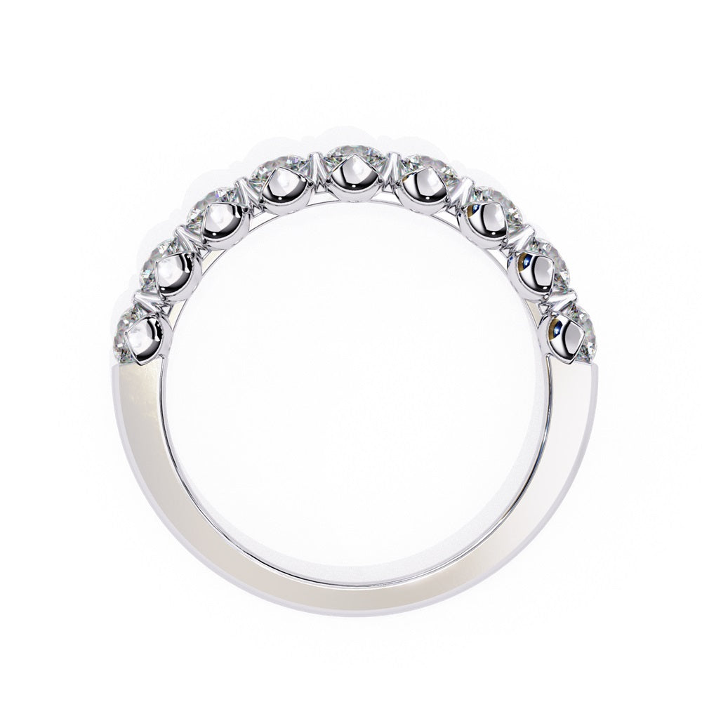 The Minimal Magic Diamond Band by Niraa is a luxury accessory featuring round, sparkling white diamonds, each set in its own bezel. The diamonds catch the light brilliantly, giving this gold ring an elegant and opulent allure.