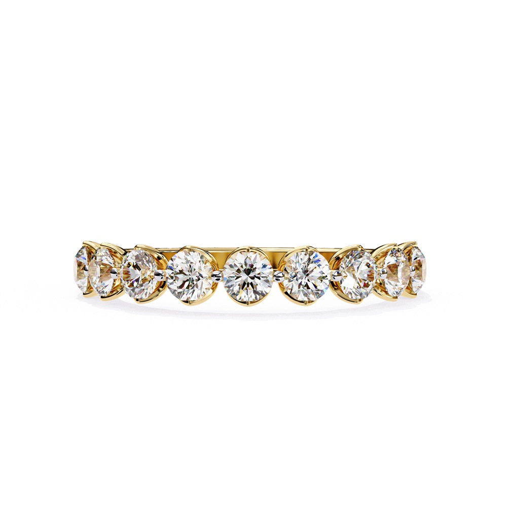 The Minimal Magic Diamond Band by Niraa is a luxury accessory featuring round, sparkling white diamonds, each set in its own bezel. The diamonds catch the light brilliantly, giving this gold ring an elegant and opulent allure.