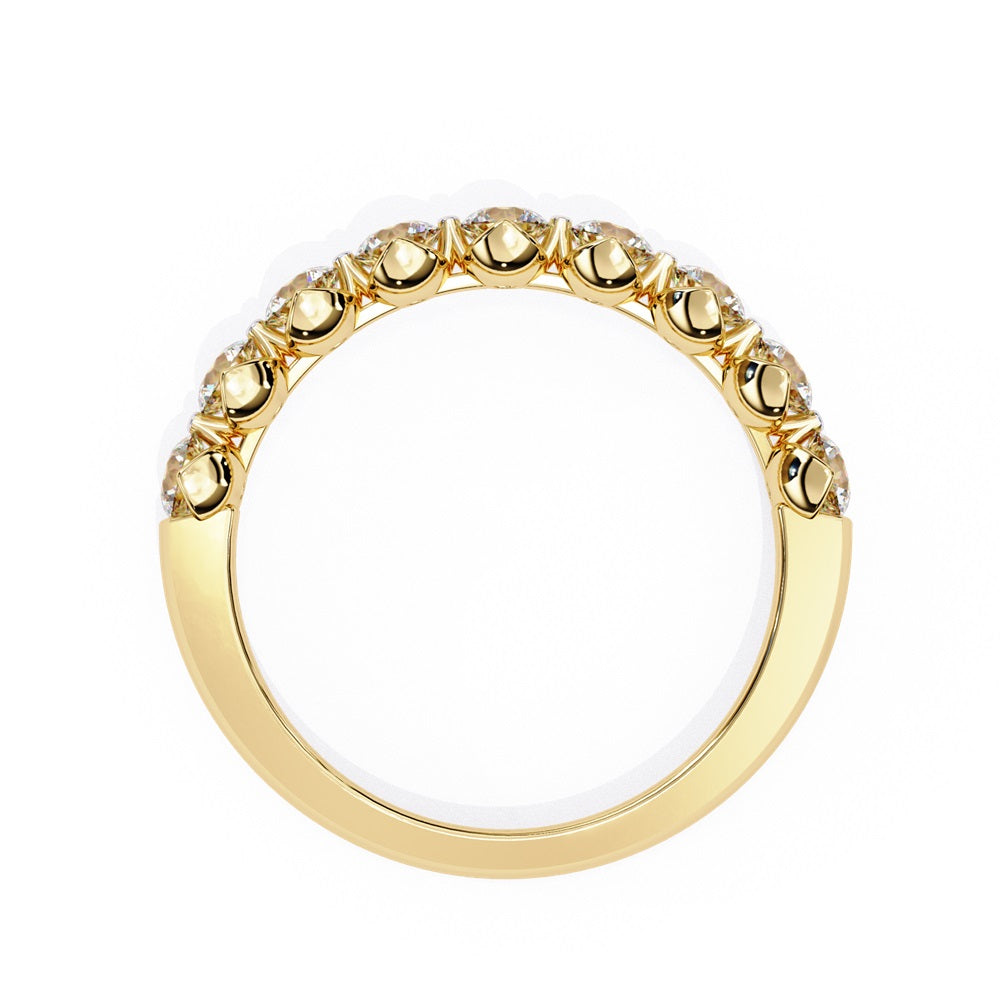 The Minimal Magic Diamond Band by Niraa is a luxury accessory featuring round, sparkling white diamonds, each set in its own bezel. The diamonds catch the light brilliantly, giving this gold ring an elegant and opulent allure.