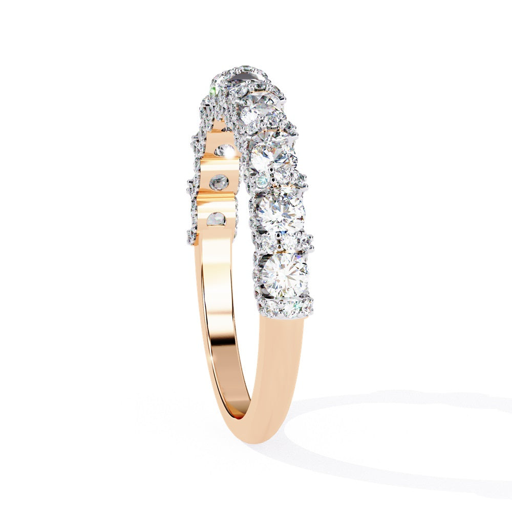 Discover the allure of Niraas Garland Diamond Band, a luxurious gold ring adorned with large, round, sparkling diamonds elegantly covering two-thirds of its surface, beautifully revealing the gleaming gold beneath.