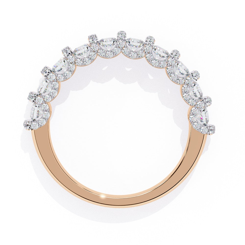 Discover the allure of Niraas Garland Diamond Band, a luxurious gold ring adorned with large, round, sparkling diamonds elegantly covering two-thirds of its surface, beautifully revealing the gleaming gold beneath.