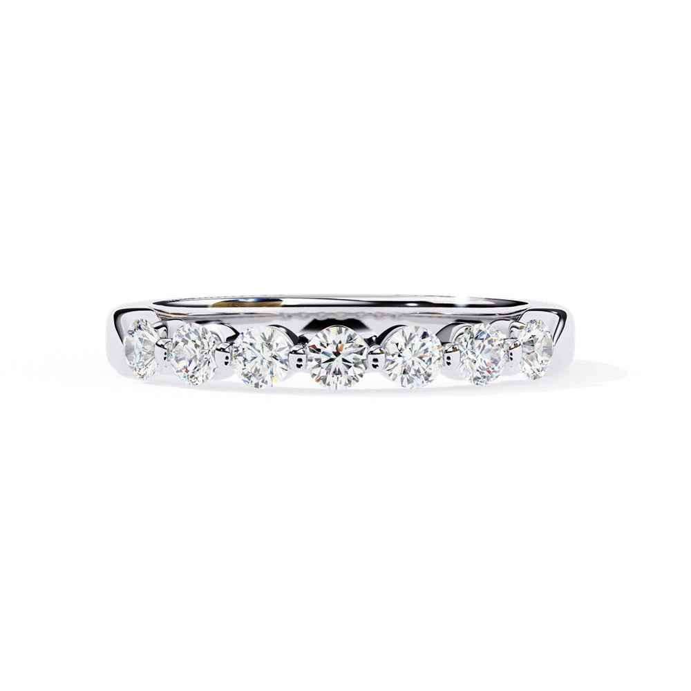 The Niraa Seven Star Diamond Band is a luxurious gold ring with seven round, evenly spaced, sparkling diamonds, offering elegance and sophistication. The exquisite accessory is beautifully showcased on a plain white background.