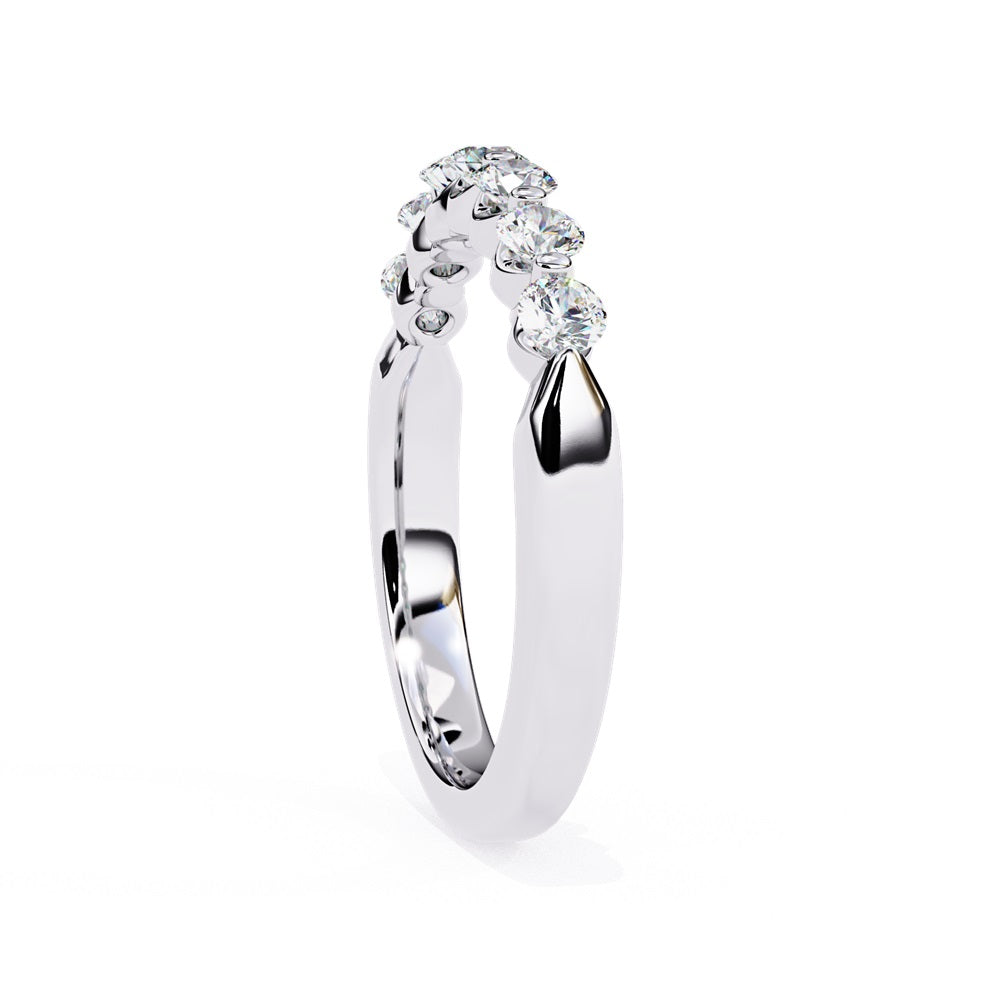 The Niraa Seven Star Diamond Band is a luxurious gold ring with seven round, evenly spaced, sparkling diamonds, offering elegance and sophistication. The exquisite accessory is beautifully showcased on a plain white background.