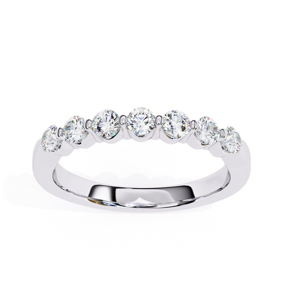 The Niraa Seven Star Diamond Band is a luxurious gold ring with seven round, evenly spaced, sparkling diamonds, offering elegance and sophistication. The exquisite accessory is beautifully showcased on a plain white background.
