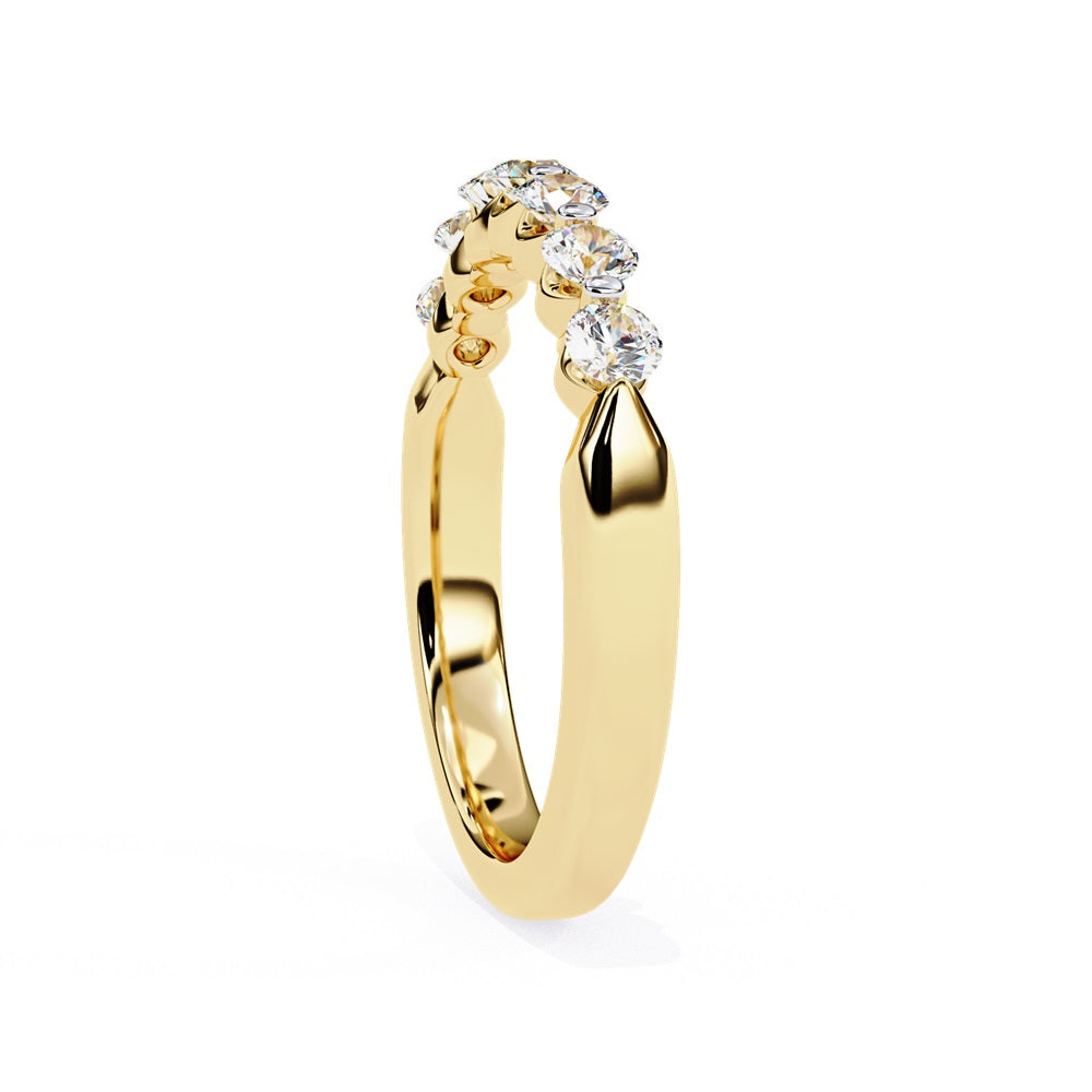 The Niraa Seven Star Diamond Band is a luxurious gold ring with seven round, evenly spaced, sparkling diamonds, offering elegance and sophistication. The exquisite accessory is beautifully showcased on a plain white background.