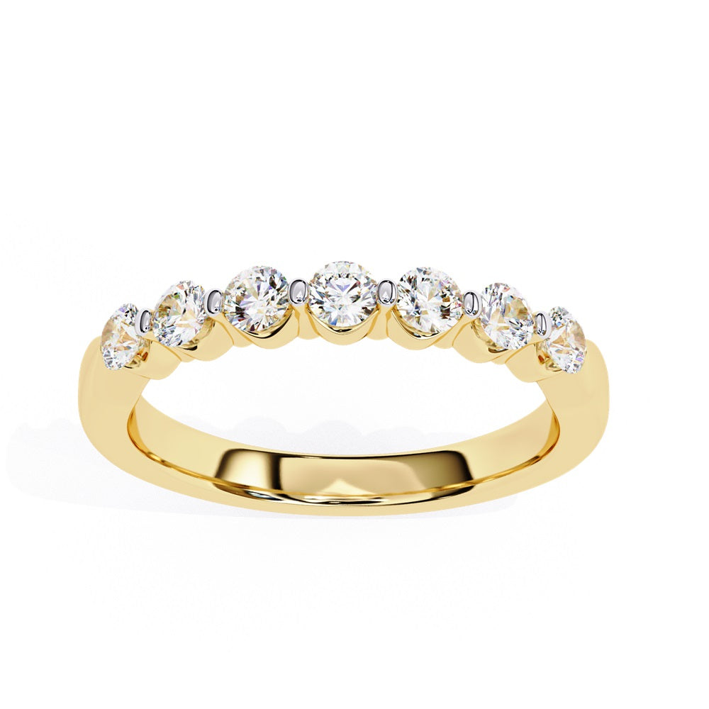 The Niraa Seven Star Diamond Band is a luxurious gold ring with seven round, evenly spaced, sparkling diamonds, offering elegance and sophistication. The exquisite accessory is beautifully showcased on a plain white background.