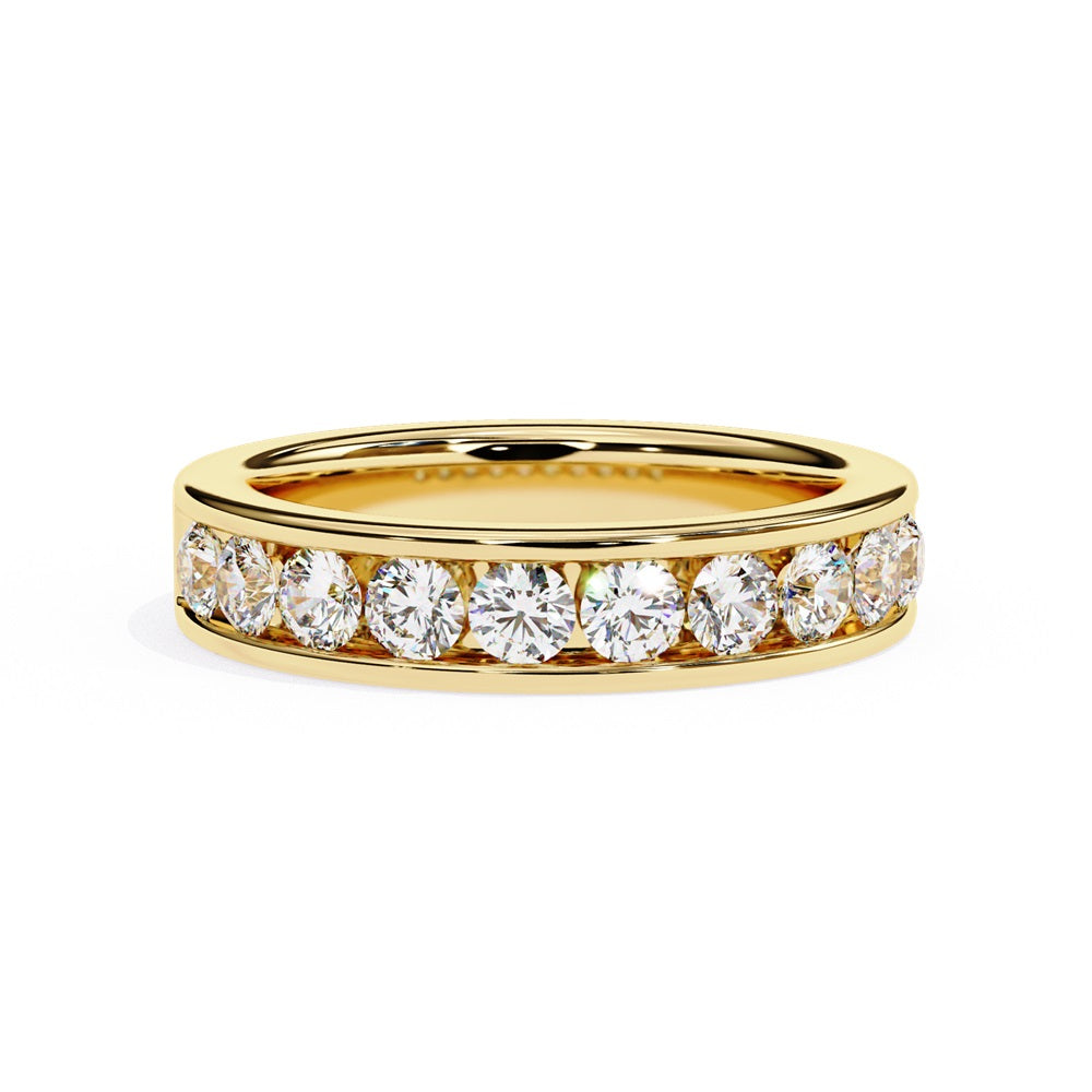 The Niraa Classic Channel Diamond Band, a luxury gold ring adorned with a row of small round diamonds, is elegantly displayed horizontally against a plain white background, highlighting its sparkling design and lustrous finish.