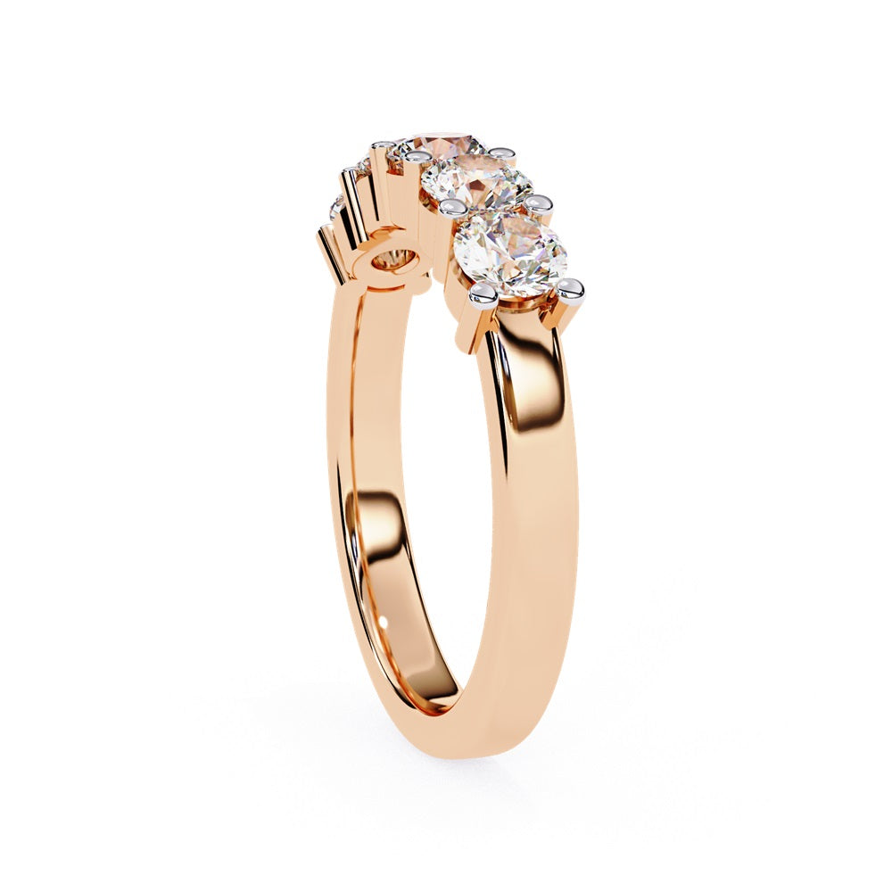 Niraas Five Stone Diamond Band is a stunning gold ring with five round brilliant-cut diamonds in an elegant prong setting. Each stone comes with a diamond certificate, highlighting their clarity and sparkle against the sleek gold band.