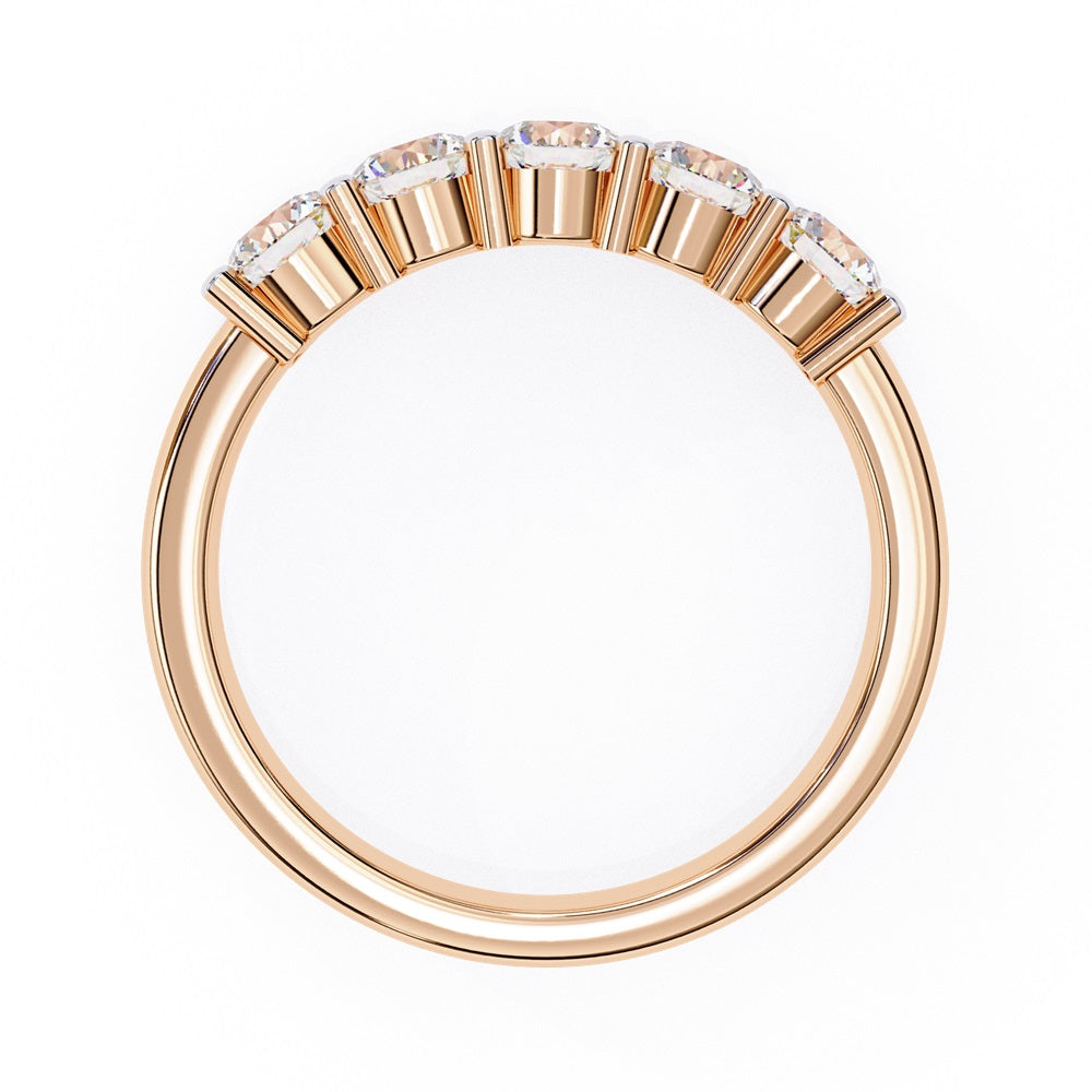 Niraas Five Stone Diamond Band is a stunning gold ring with five round brilliant-cut diamonds in an elegant prong setting. Each stone comes with a diamond certificate, highlighting their clarity and sparkle against the sleek gold band.
