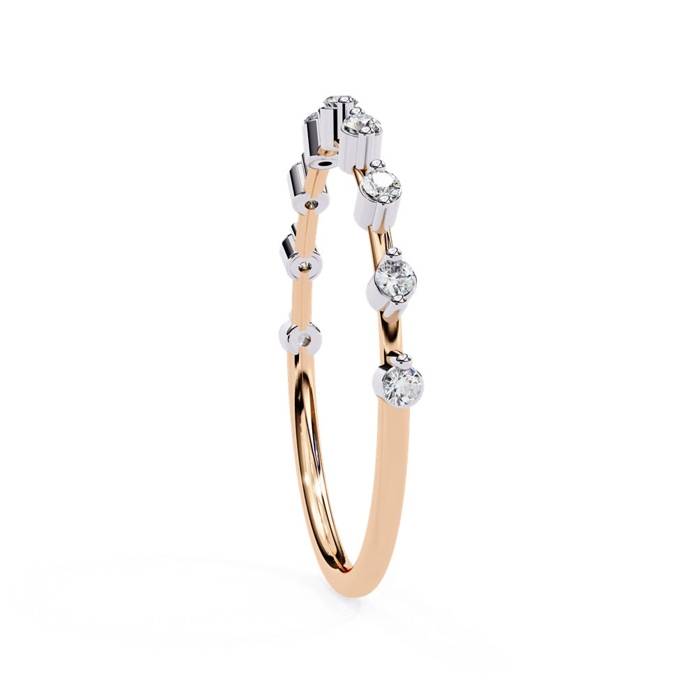 The Sunrise Diamond Band by Niraa is a luxurious gold ring featuring an elegant alternating pattern of round and baguette-cut diamonds set in a row, beautifully showcasing the sparkling gemstones against its smooth surface.