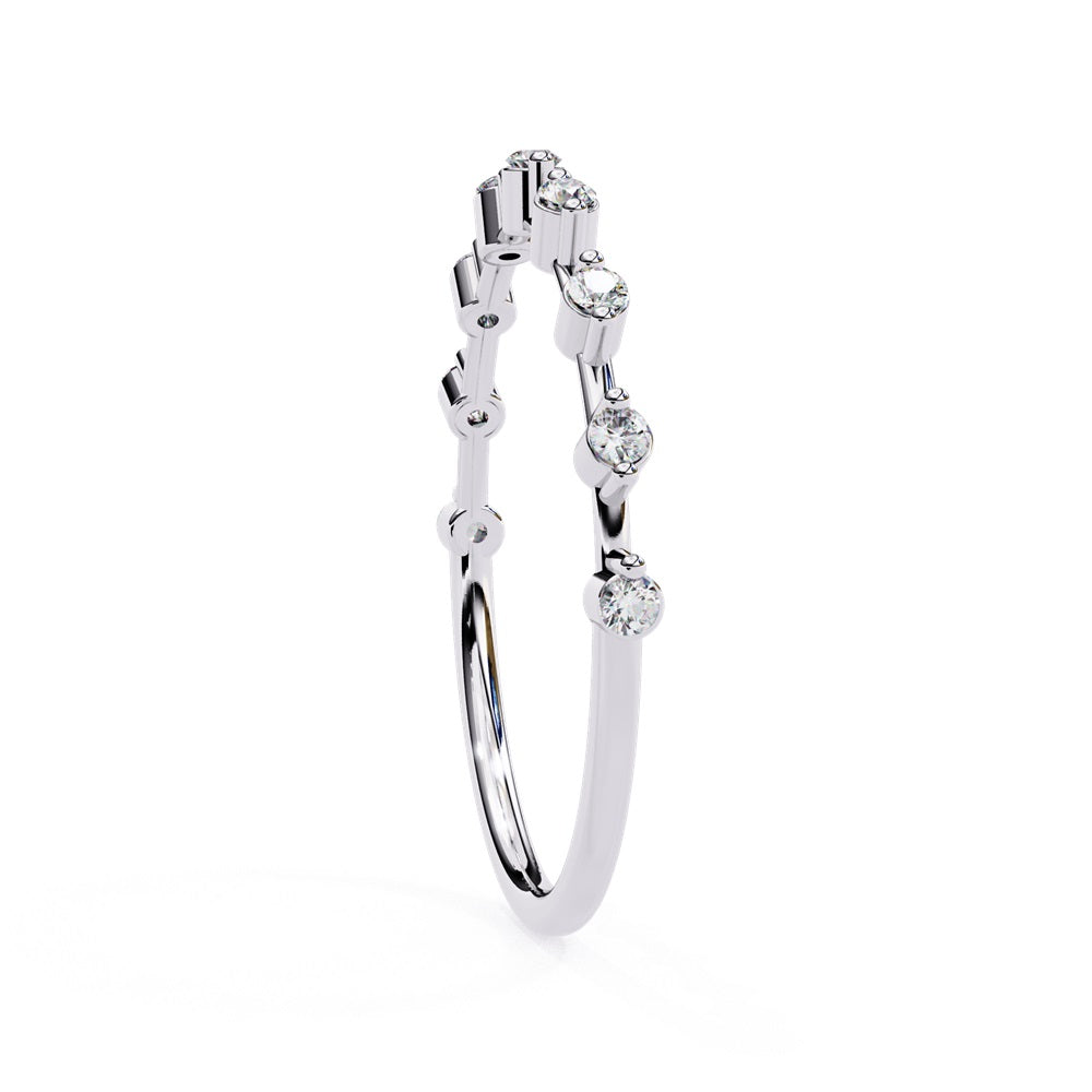 The Sunrise Diamond Band by Niraa is a luxurious gold ring featuring an elegant alternating pattern of round and baguette-cut diamonds set in a row, beautifully showcasing the sparkling gemstones against its smooth surface.