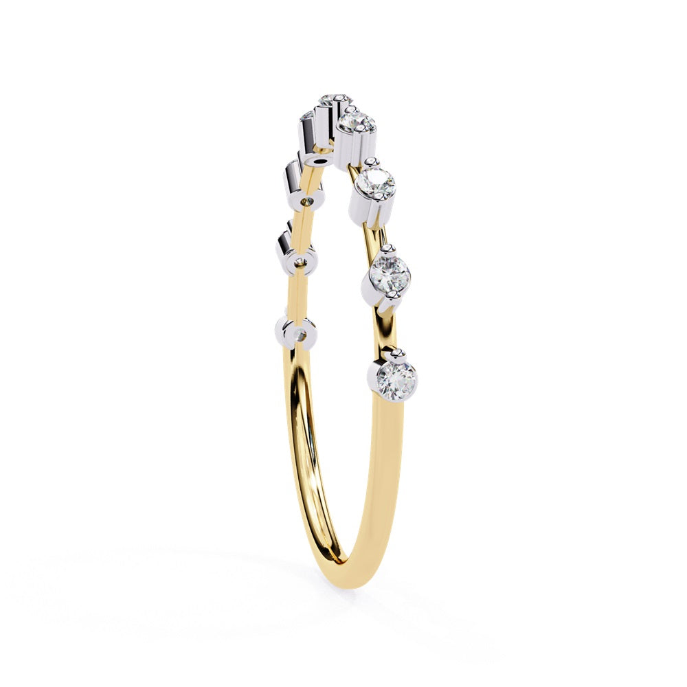 The Sunrise Diamond Band by Niraa is a luxurious gold ring featuring an elegant alternating pattern of round and baguette-cut diamonds set in a row, beautifully showcasing the sparkling gemstones against its smooth surface.