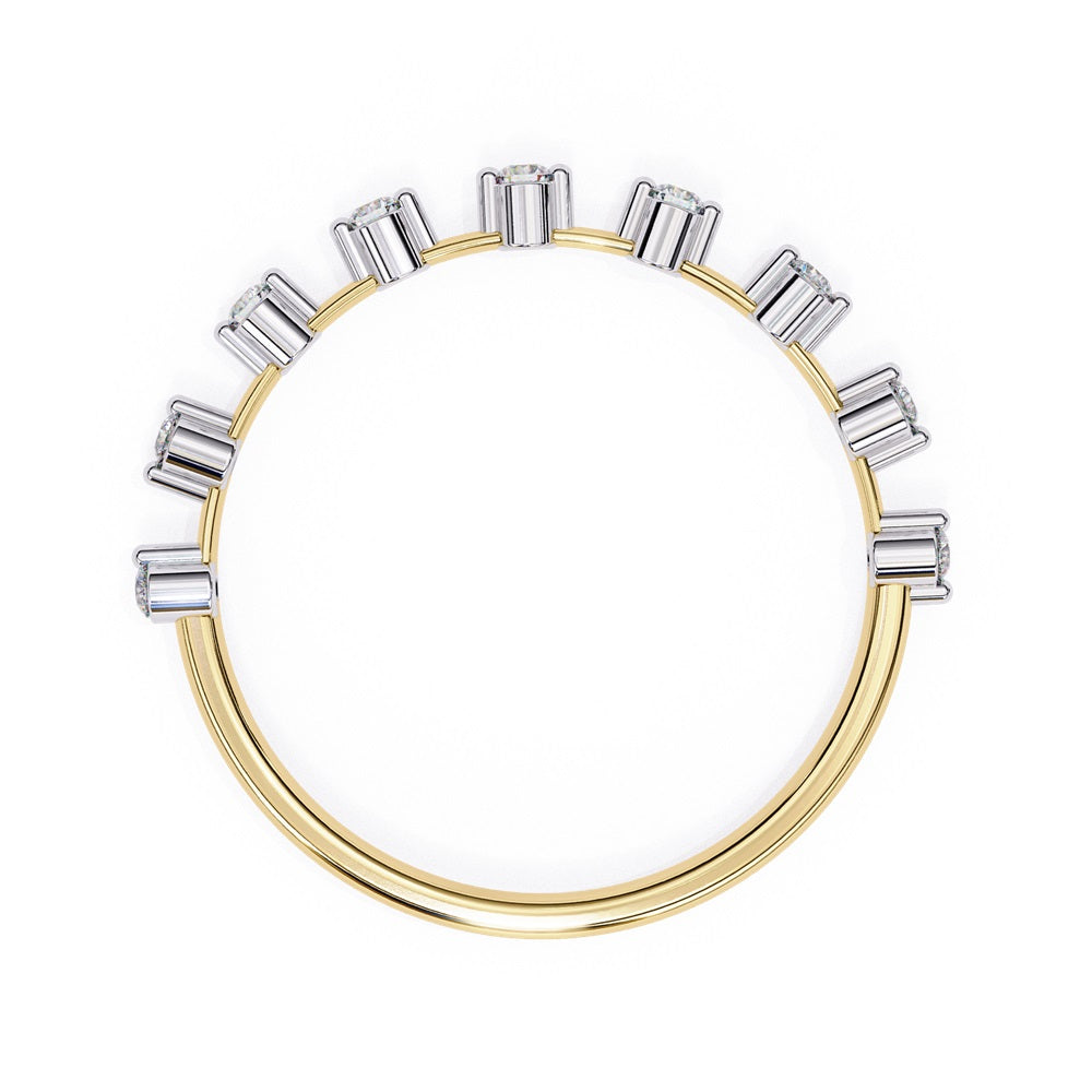 The Sunrise Diamond Band by Niraa is a luxurious gold ring featuring an elegant alternating pattern of round and baguette-cut diamonds set in a row, beautifully showcasing the sparkling gemstones against its smooth surface.