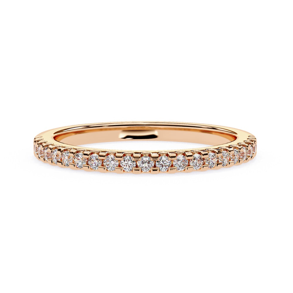 The Niraa Hope Diamond Band is a luxurious gold ring featuring a single row of small, sparkling diamonds. Its polished finish enhances the brilliance, making it truly exquisite.