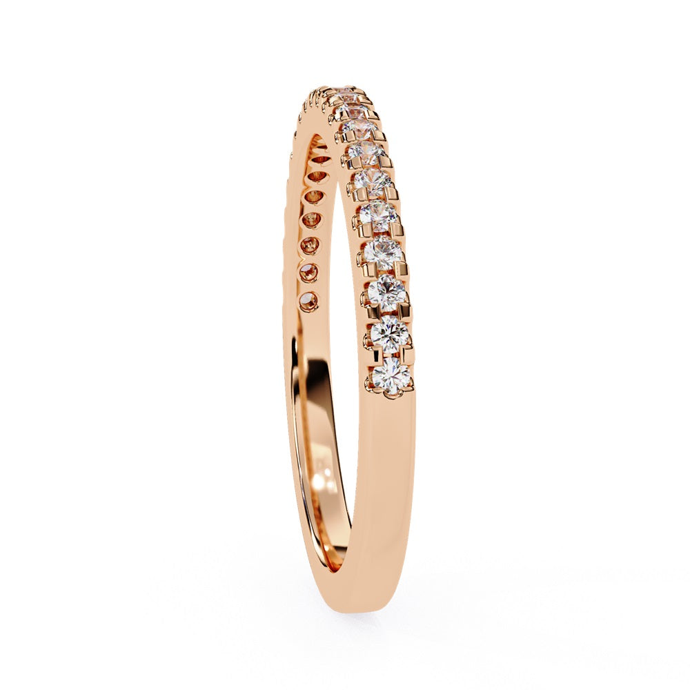The Niraa Hope Diamond Band is a luxurious gold ring featuring a single row of small, sparkling diamonds. Its polished finish enhances the brilliance, making it truly exquisite.