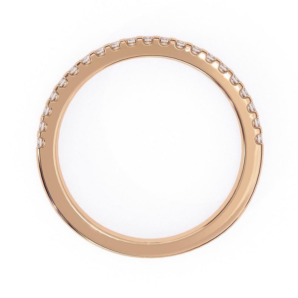 The Niraa Hope Diamond Band is a luxurious gold ring featuring a single row of small, sparkling diamonds. Its polished finish enhances the brilliance, making it truly exquisite.