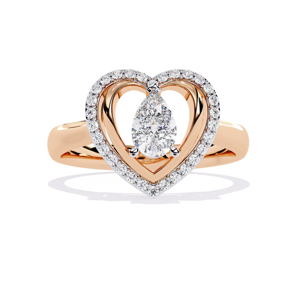 A pear-shaped diamond ring in gold, encircled by smaller diamonds, forming a heart shape around the centerpiece.