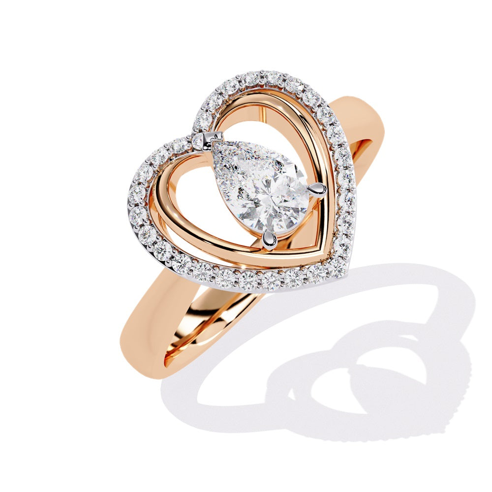A pear-shaped diamond ring in gold, encircled by smaller diamonds, forming a heart shape around the centerpiece.