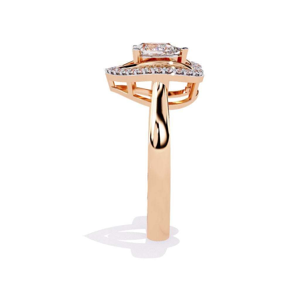 A pear-shaped diamond ring in gold, encircled by smaller diamonds, forming a heart shape around the centerpiece.