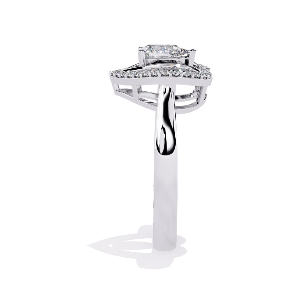 A pear-shaped diamond ring in gold, encircled by smaller diamonds, forming a heart shape around the centerpiece.