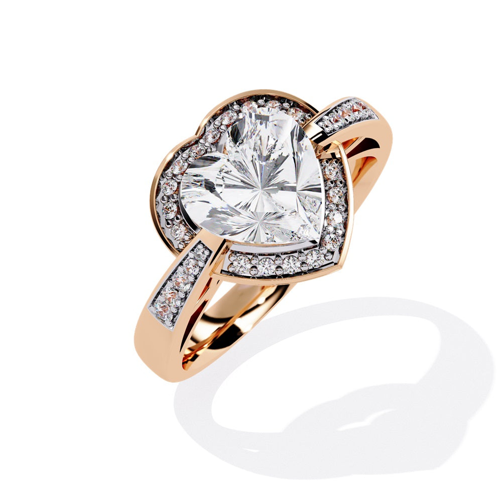 A heart-shaped diamond ring in gold, featuring a solitaire design with a halo of smaller diamonds surrounding it.