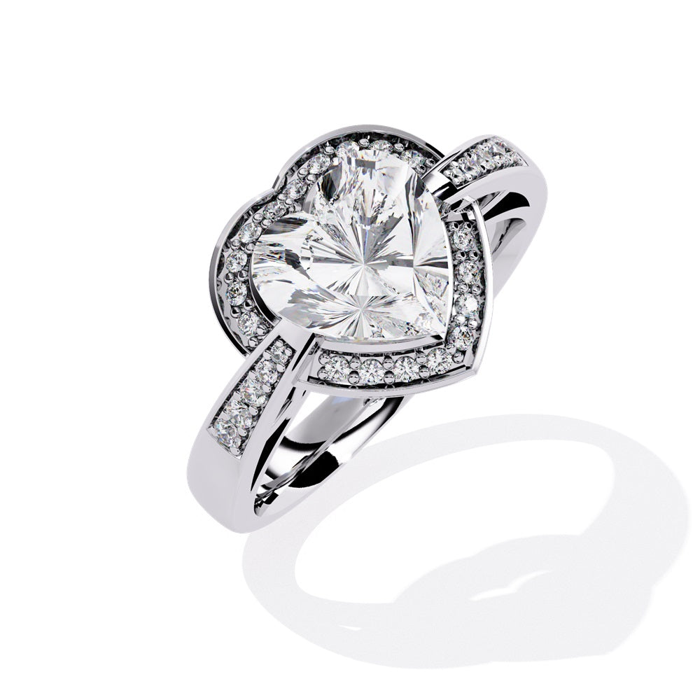 A heart-shaped diamond ring in gold, featuring a solitaire design with a halo of smaller diamonds surrounding it.