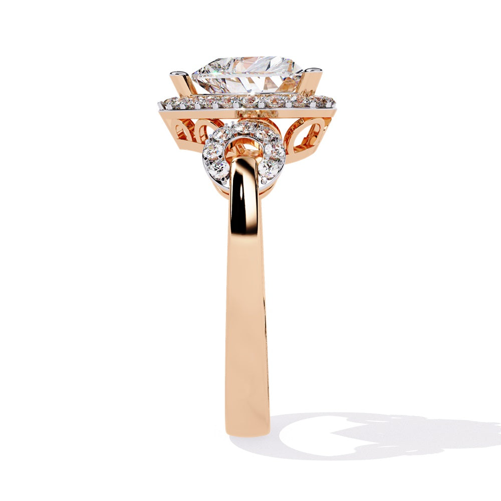 A heart-shaped diamond ring in gold, featuring a solitaire design with a halo of smaller diamonds surrounding it.