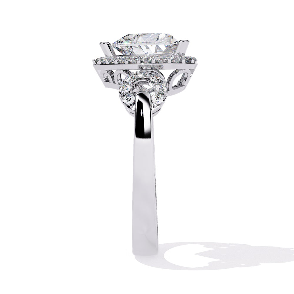 A heart-shaped diamond ring in gold, featuring a solitaire design with a halo of smaller diamonds surrounding it.