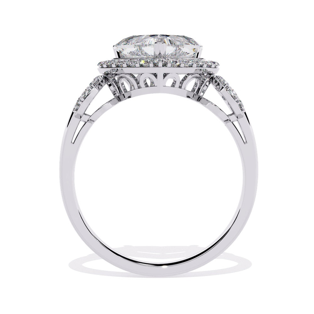 A heart-shaped diamond ring in gold, featuring a solitaire design with a halo of smaller diamonds surrounding it.