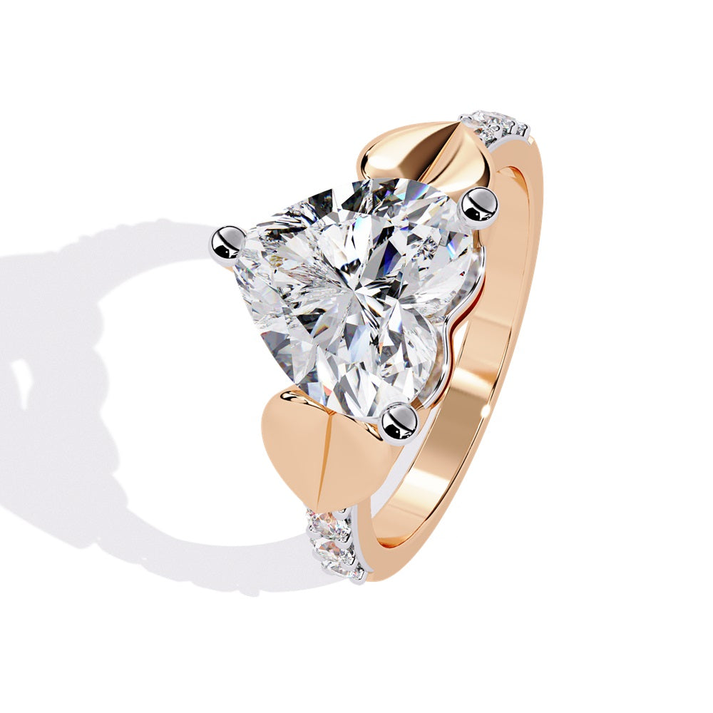 A stunning heart-shaped diamond engagement ring in gold featuring two gold hearts on either sides, perfect for a romantic proposal.