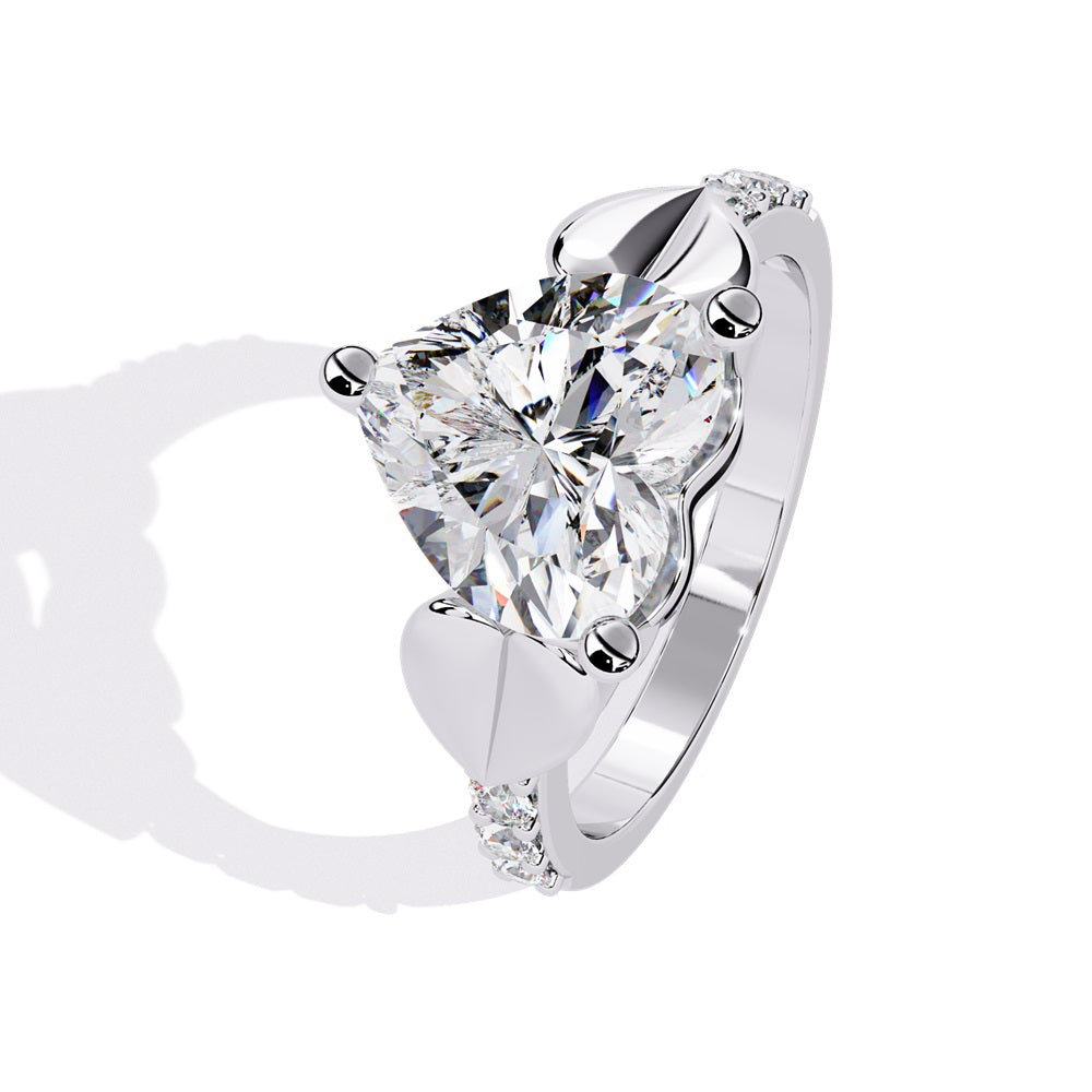 A stunning heart-shaped diamond engagement ring in gold featuring two gold hearts on either sides, perfect for a romantic proposal.