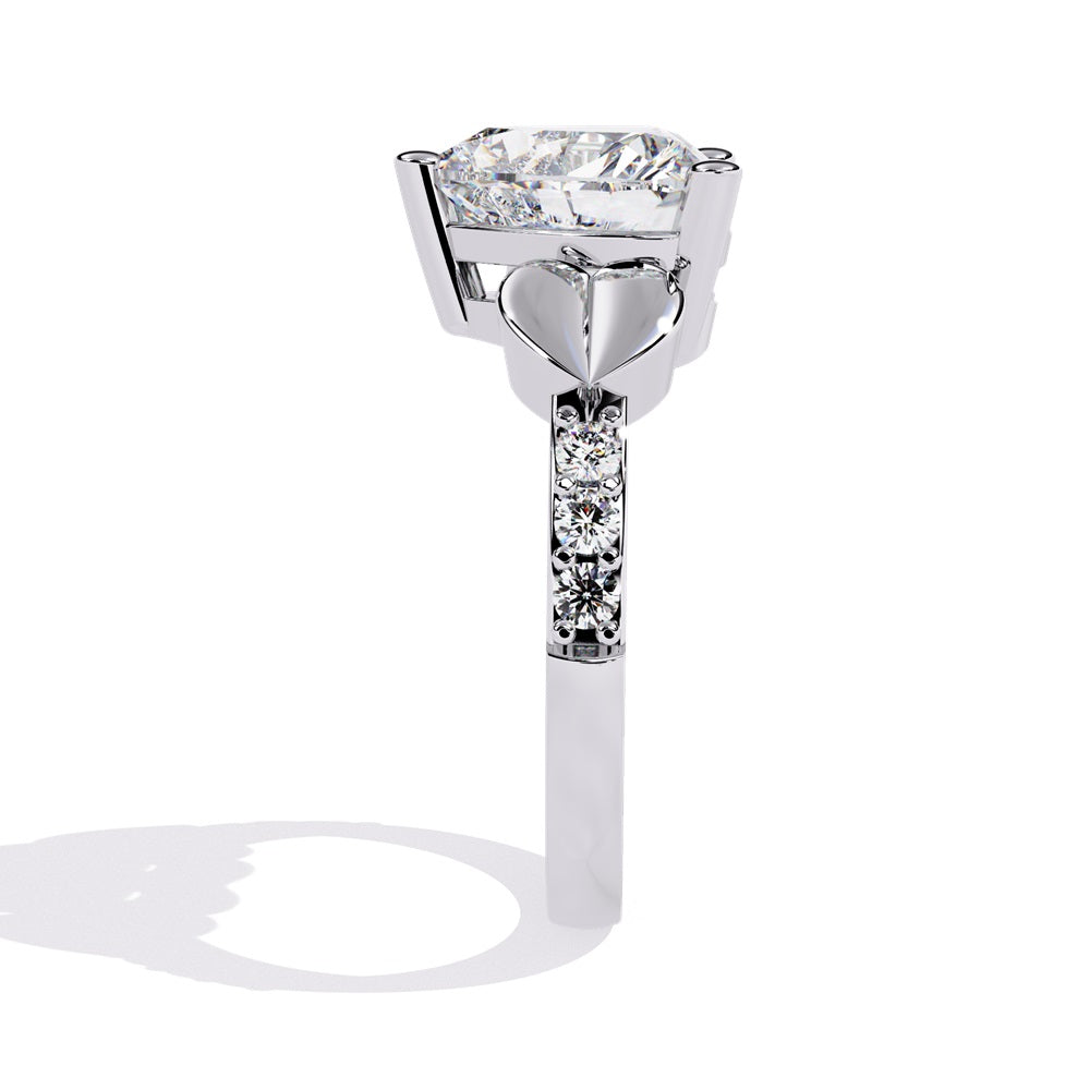 A stunning heart-shaped diamond engagement ring in gold featuring two gold hearts on either sides, perfect for a romantic proposal.
