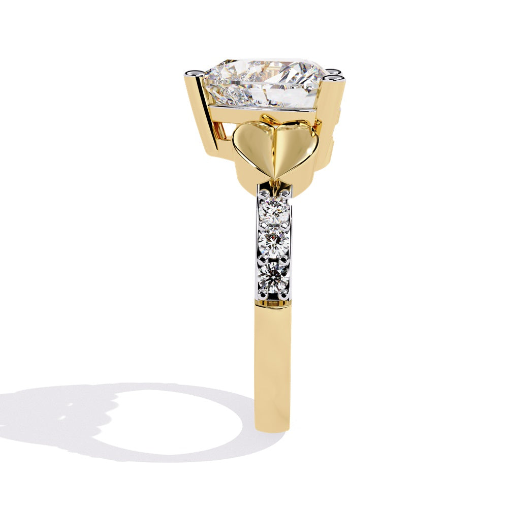 A stunning heart-shaped diamond engagement ring in gold featuring two gold hearts on either sides, perfect for a romantic proposal.